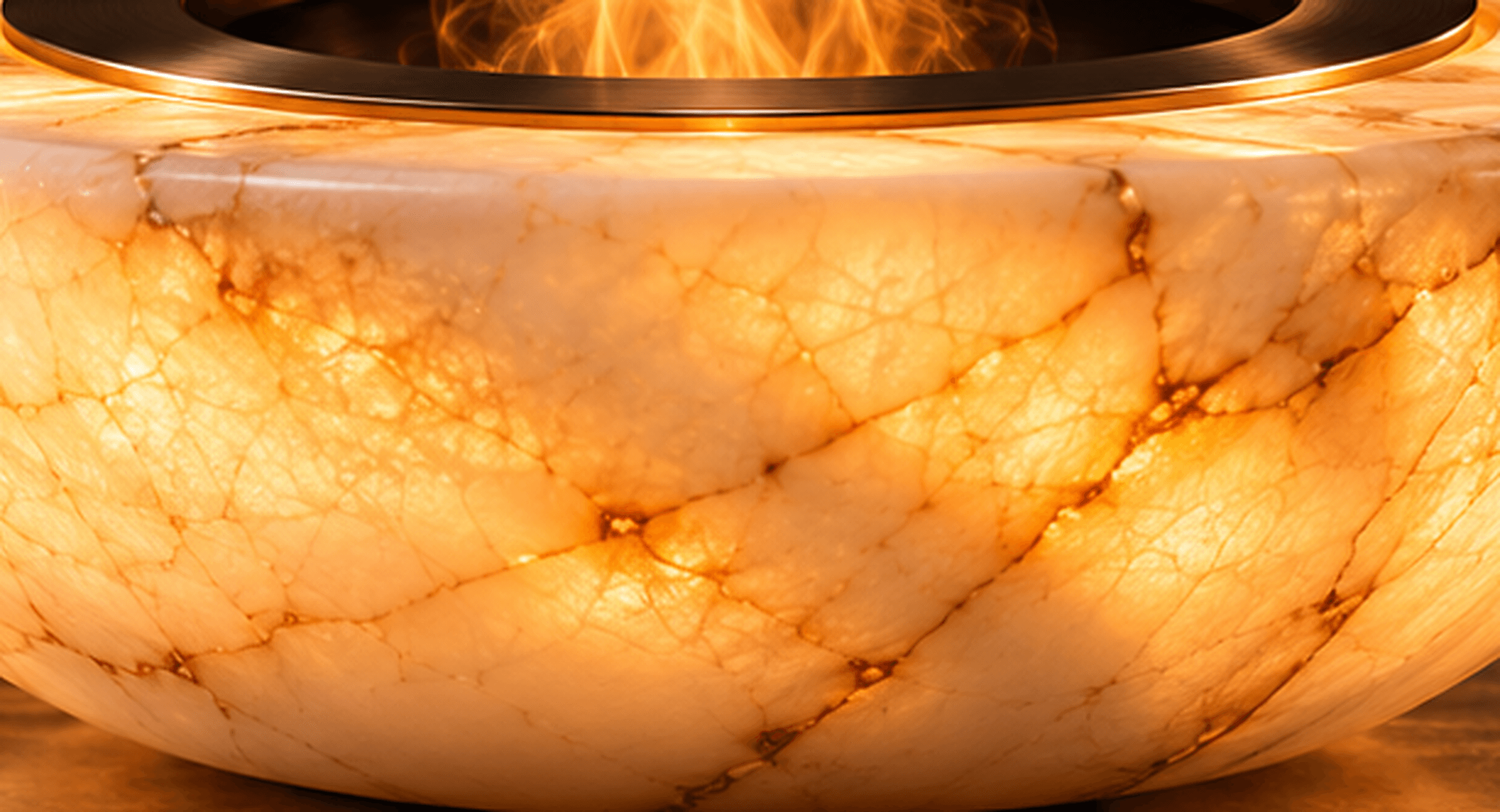 Close-up concept render of the ORUELLE exterior glowing from within, showing ivory and amber veining across the curved translucent surface.